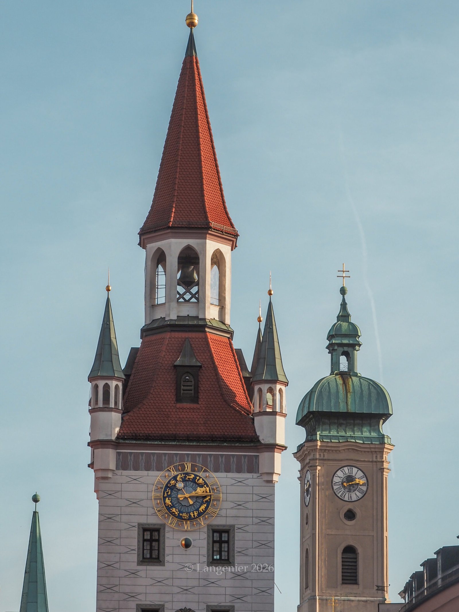 Munich Rathaus-Glockenspiel and Old Peter church tower clocks in the city center, Marienplatz, Bavaria, Germany