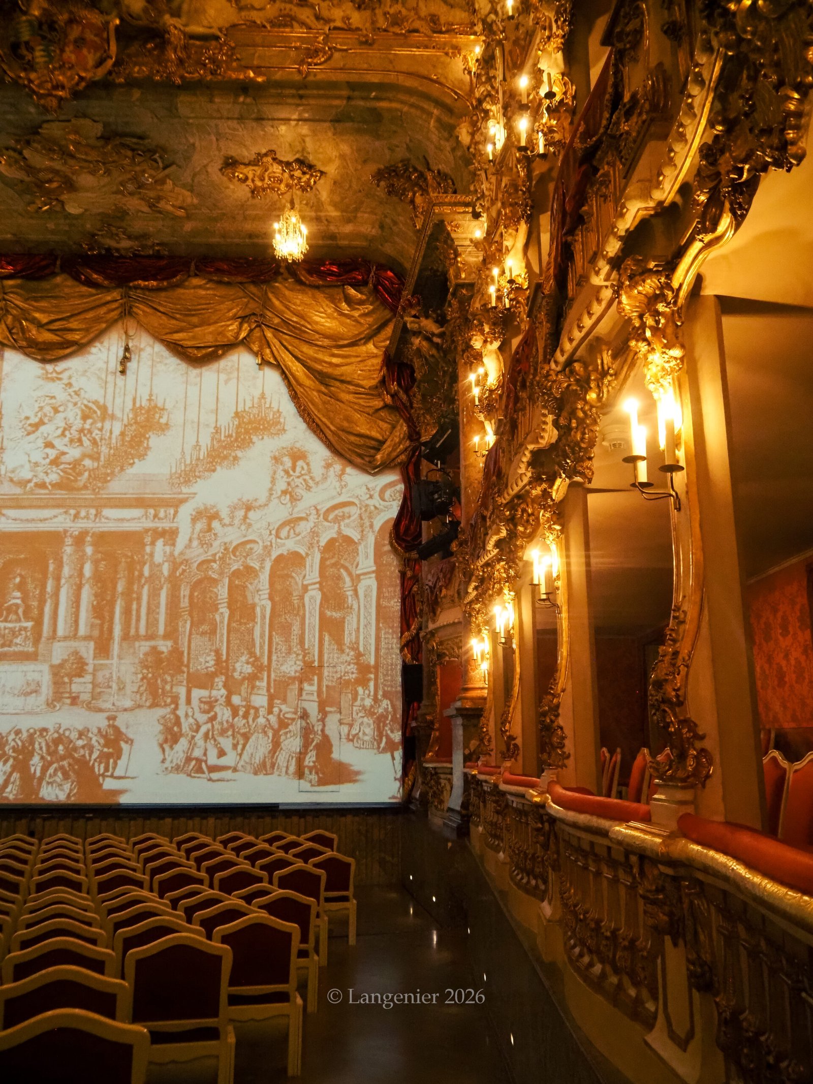 Rococo interior of the Cuvilliés Theatre in Munich, showing tiered gilded balconies, red velvet seating, and ornate ceiling chandeliers, integrated within the Munich Residenz