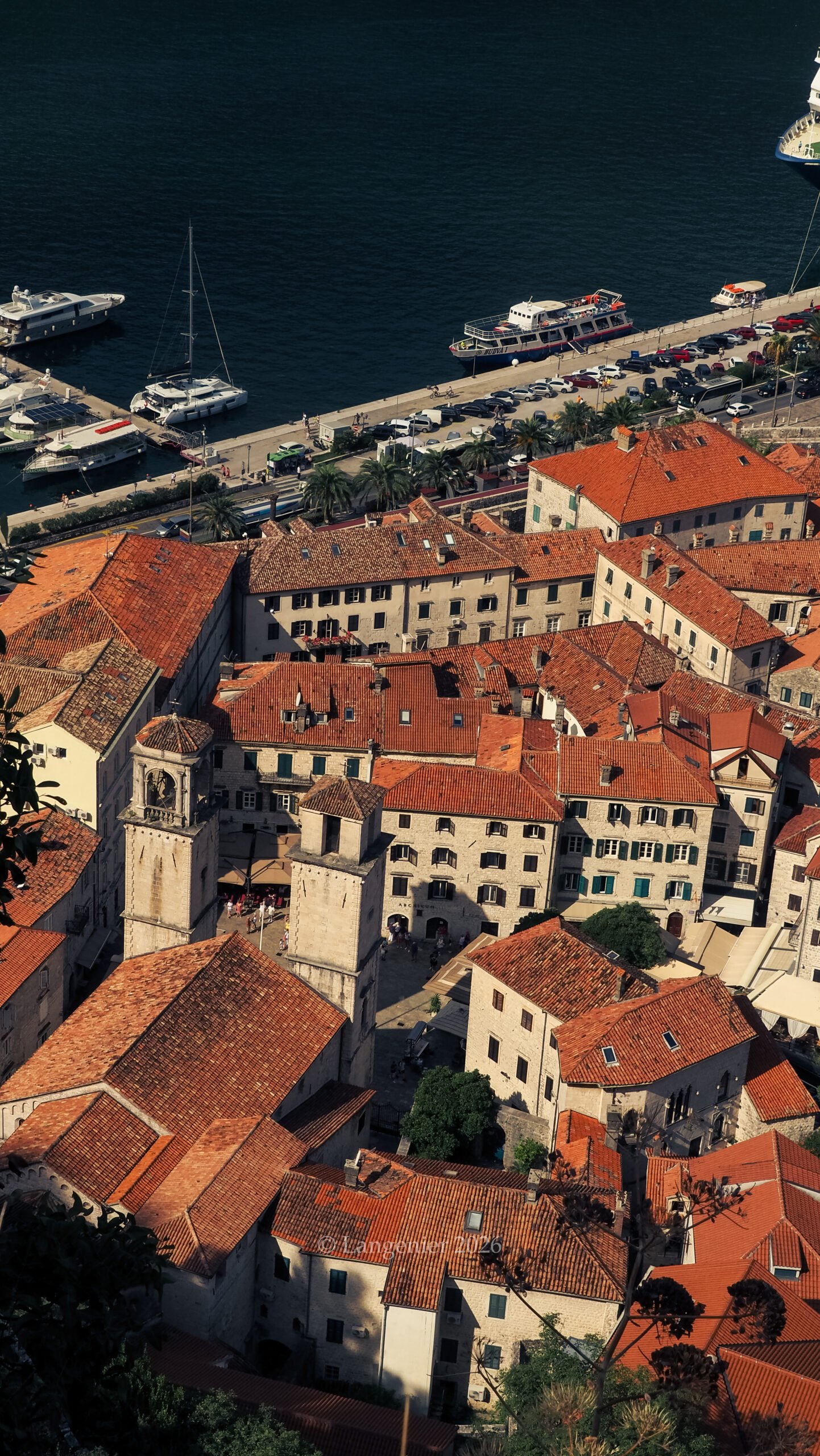 Aerial view of Kotor's old town red rooftops and harbor from the fortress trail, Bay of Kotor, Montenegro