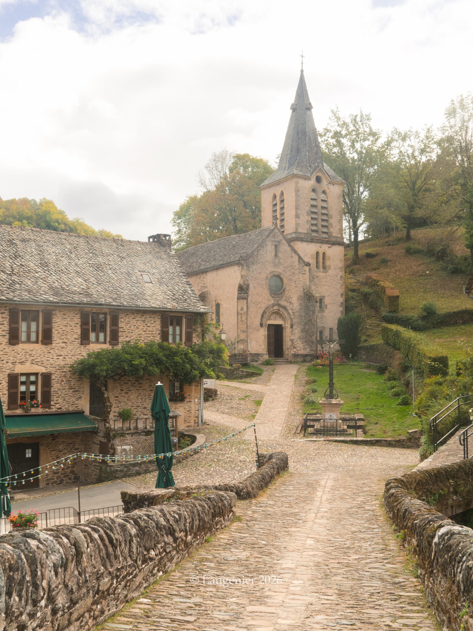 Stone bridge in Belcastel, France, leading to the picturesque Church of Sainte-Marie-Madeleine.