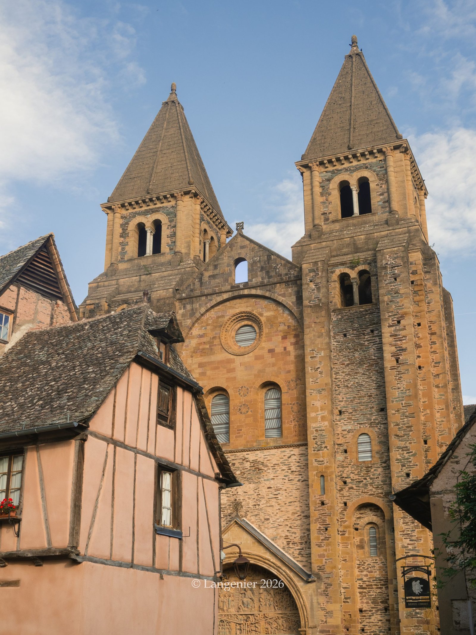 Conques Abbey rising above the stone houses at the heart of the village, Aveyron, France